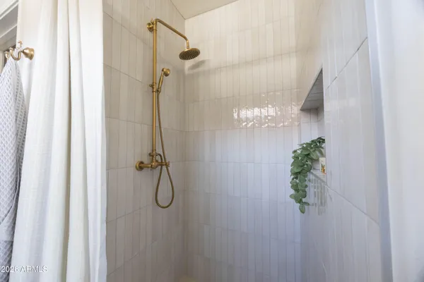 a living room with furniture potted plant and a chandelier