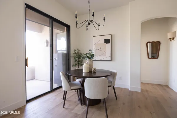 a kitchen with stainless steel appliances granite countertop a sink a stove a microwave with a dining table and chairs