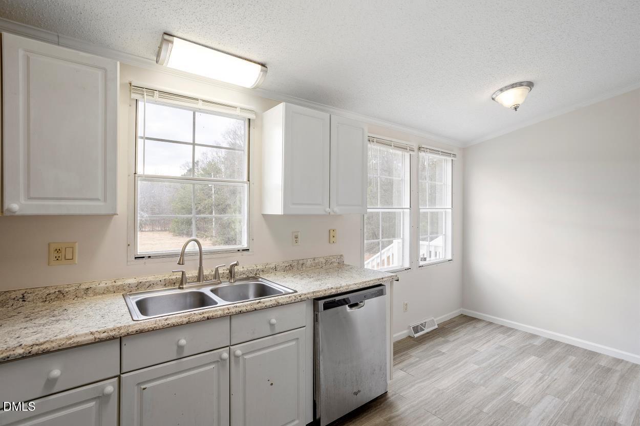 919 Red Mountain Road Rougemont, NC 27572 - Photo 14 of 32 a kitchen with a sink window and cabinets