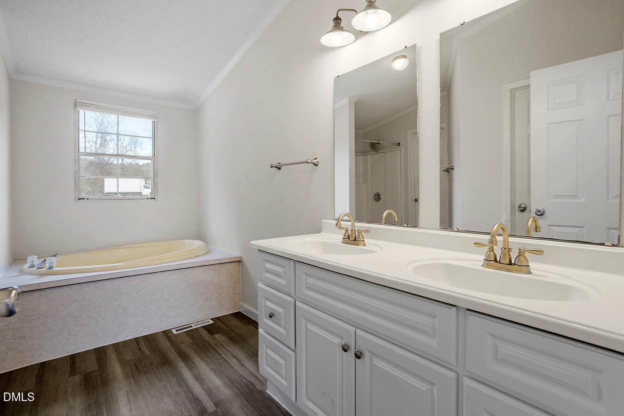919 Red Mountain Road Rougemont, NC 27572 - Photo 21 of 32 a bathroom with a tub sink and mirror