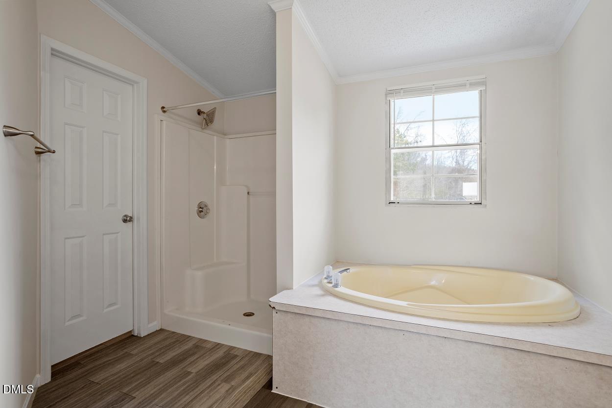 919 Red Mountain Road Rougemont, NC 27572 - Photo 22 of 32 a bathroom with a tub shower and window