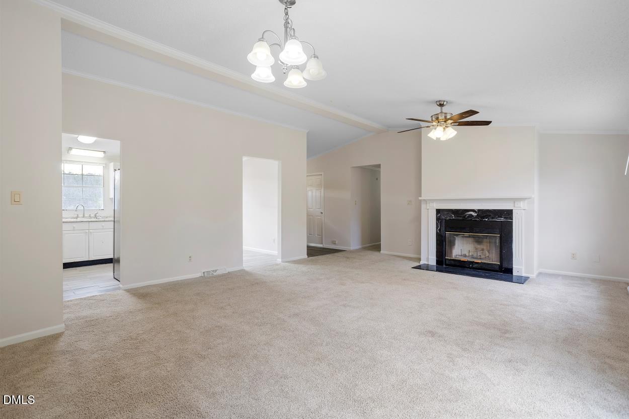 919 Red Mountain Road Rougemont, NC 27572 - Photo 9 of 32 an empty room with chandelier fan and windows