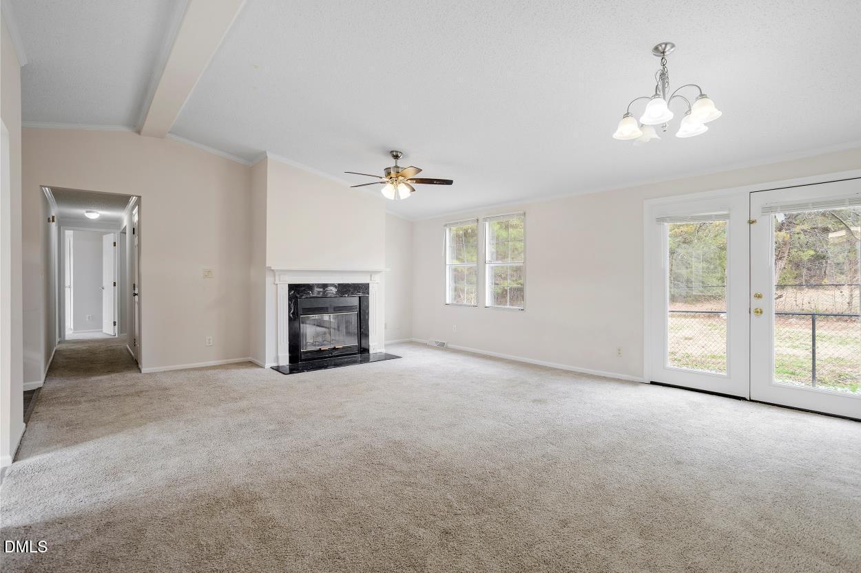919 Red Mountain Road Rougemont, NC 27572 - Photo 10 of 32 an empty room with windows and fireplace