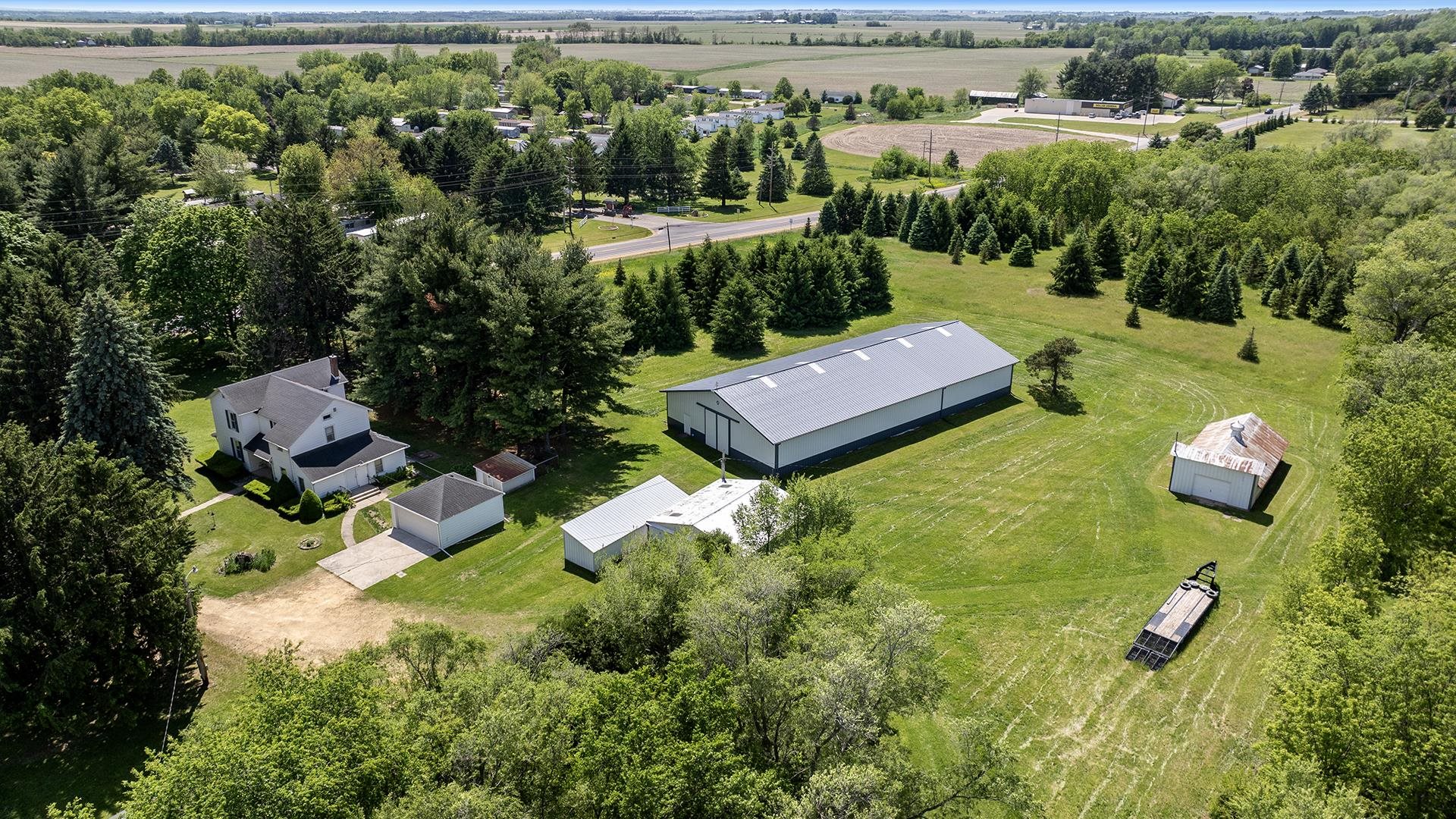 an aerial view of a house with garden space and outdoor seating