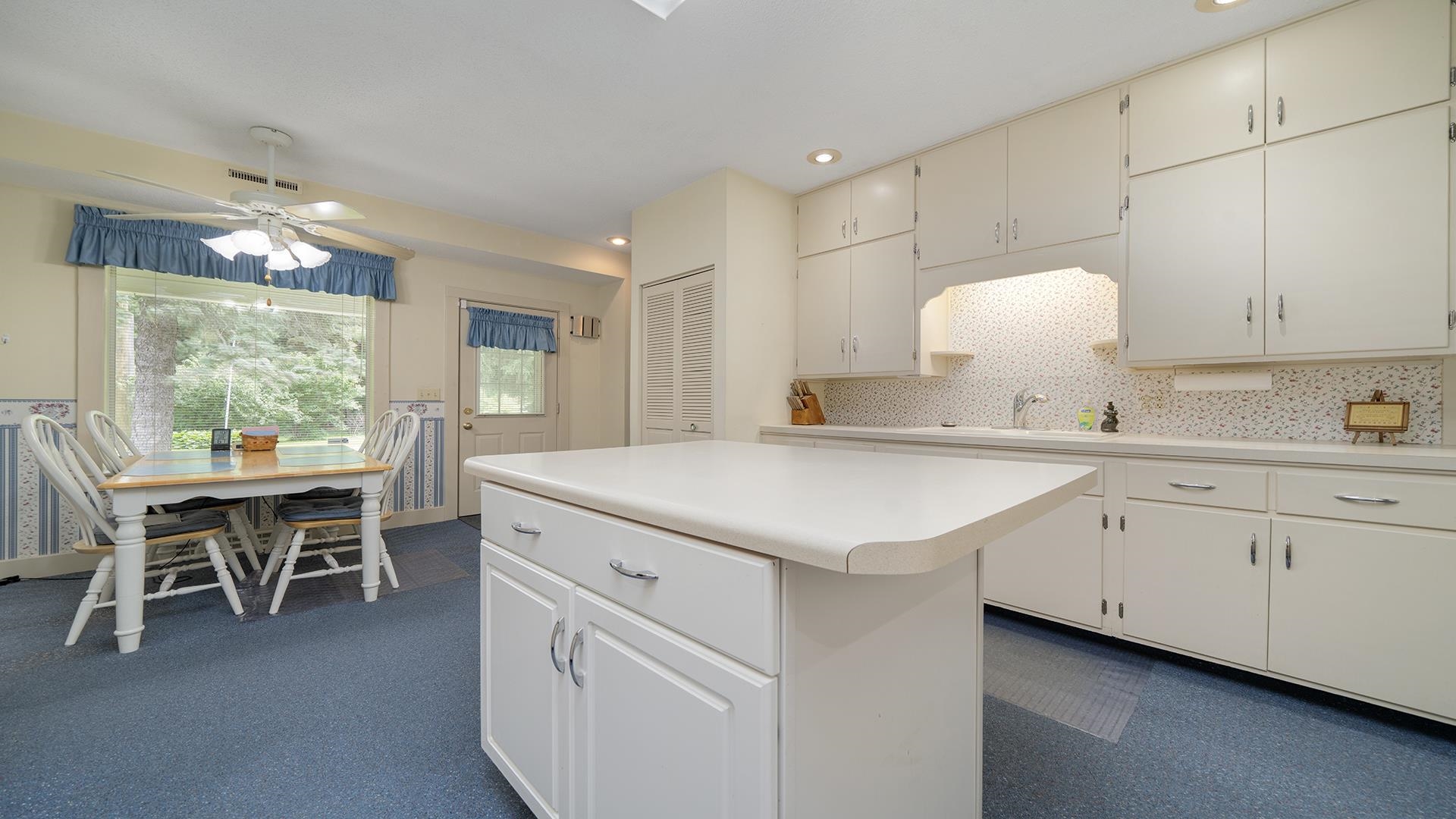 3910 Highway 64 Oregon, IL 61061 - Photo 19 of 53 a kitchen with granite countertop a sink cabinets and window