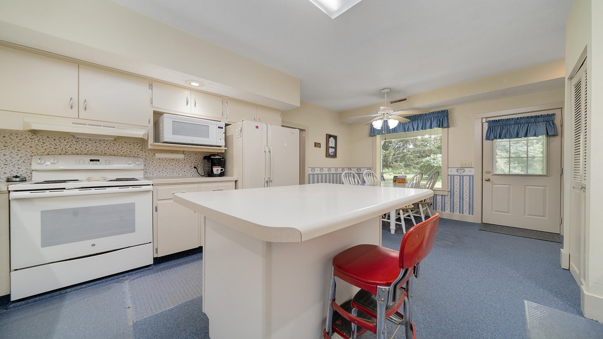 3910 Highway 64 Oregon, IL 61061 - Photo 20 of 53 a kitchen with a wooden floor a stove a sink dishwasher and a refrigerator with wooden floor