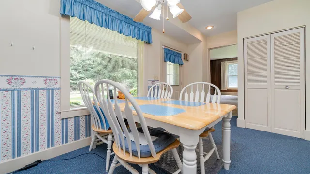 a bedroom with a bed and a dresser with mirror