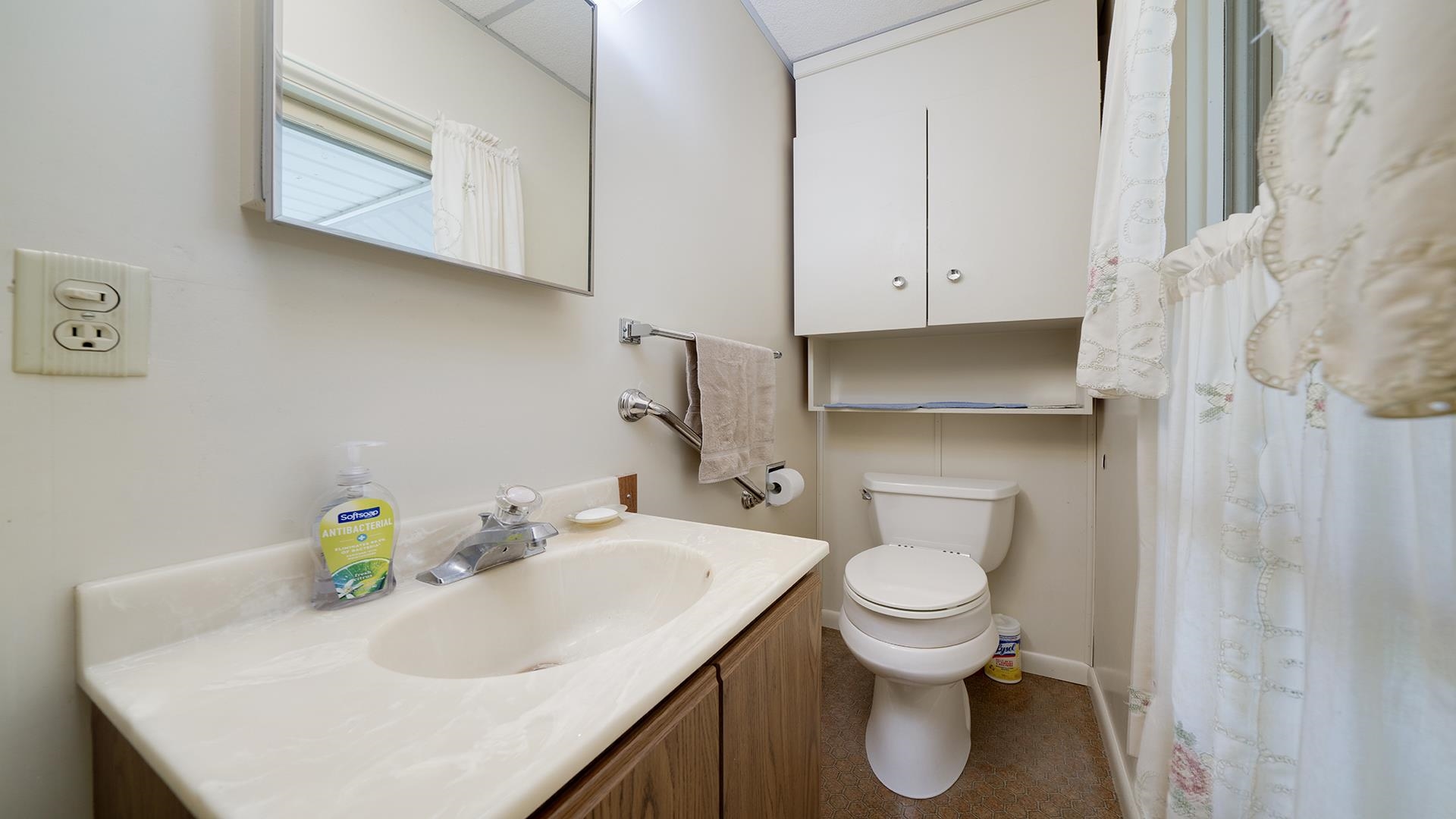3910 Highway 64 Oregon, IL 61061 - Photo 23 of 53 a bathroom with a sink a toilet and a window