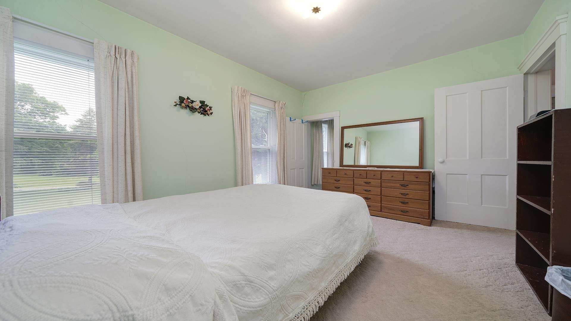 3910 Highway 64 Oregon, IL 61061 - Photo 28 of 53 a bedroom with a bed and a dresser with mirror