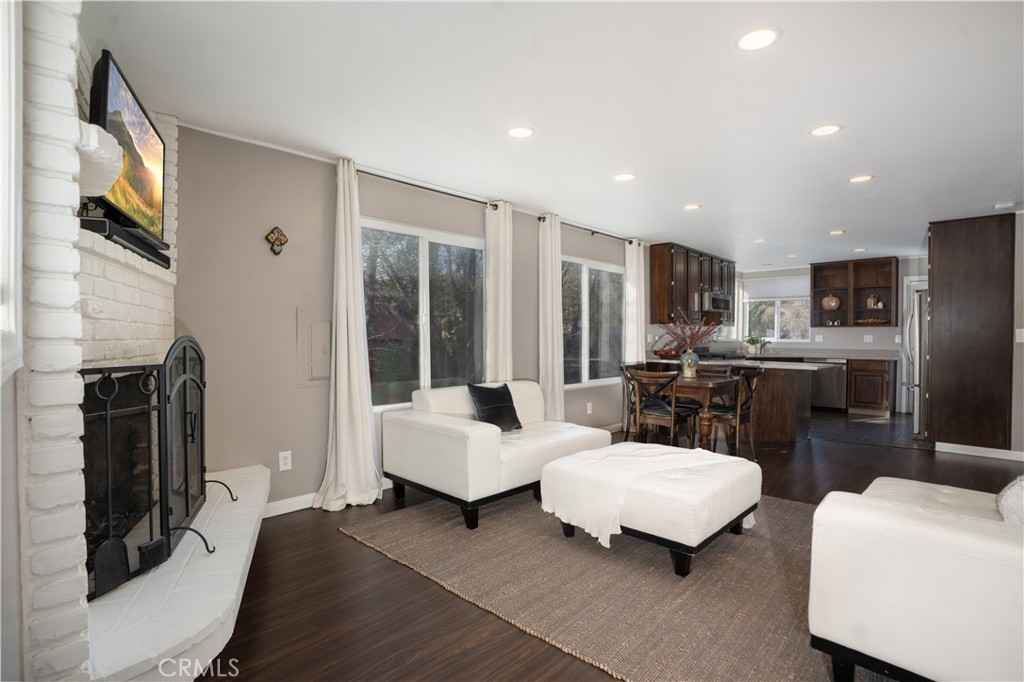 32958 Squirrel Lane Running Springs, CA 92382 - Photo 12 of 40 a living room with furniture and a fireplace