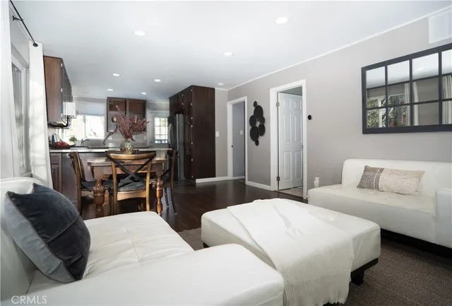 a bedroom with a bed a table window and couch