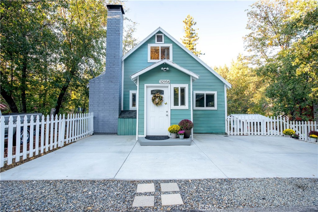 32958 Squirrel Lane Running Springs, CA 92382 - Photo 2 of 40 a front view of a house with garden