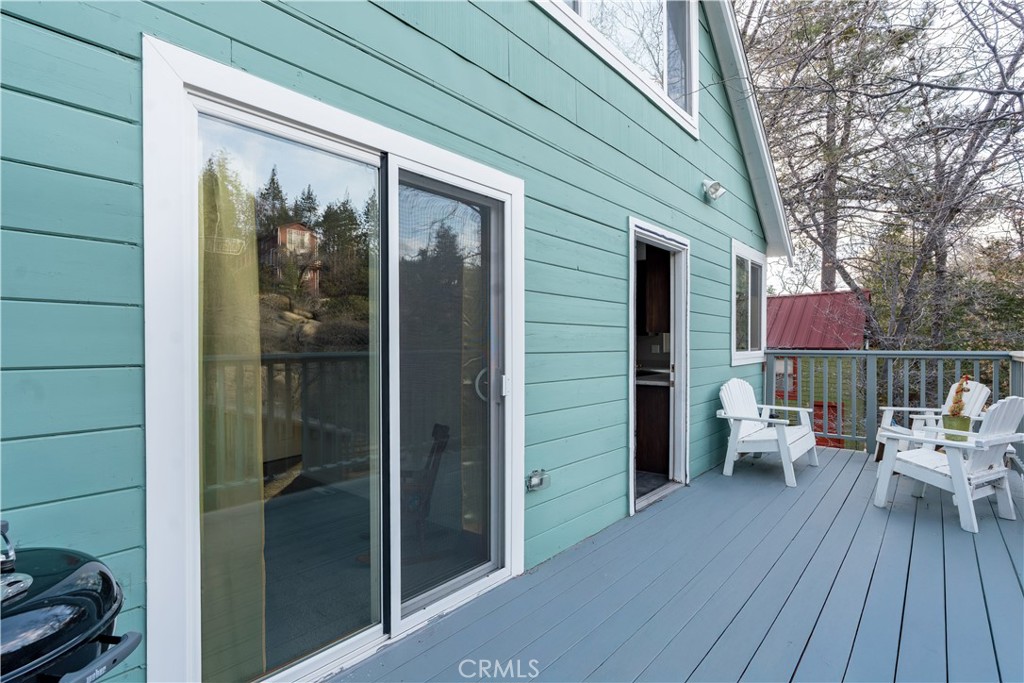 32958 Squirrel Lane Running Springs, CA 92382 - Photo 23 of 40 a balcony with furniture and wooden floor