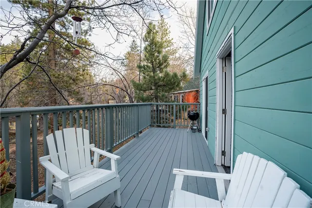 a view of balcony with wooden floor and outdoor seating