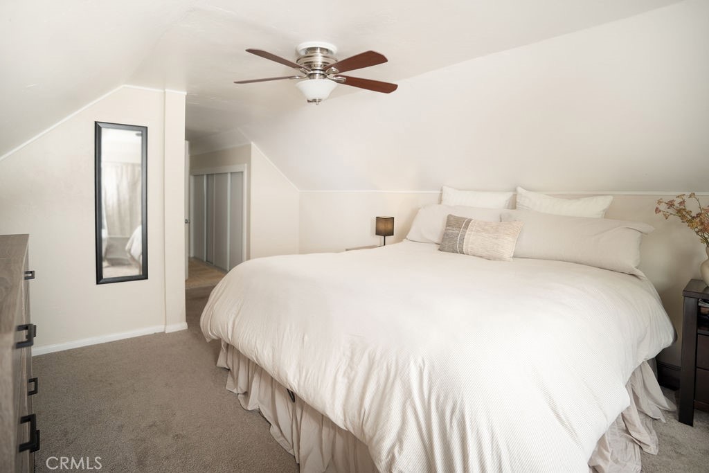 32958 Squirrel Lane Running Springs, CA 92382 - Photo 29 of 40 a spacious bedroom with a bed and a ceiling fan