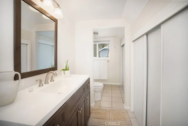 a en suite bathroom with a sink a mirror and a shower