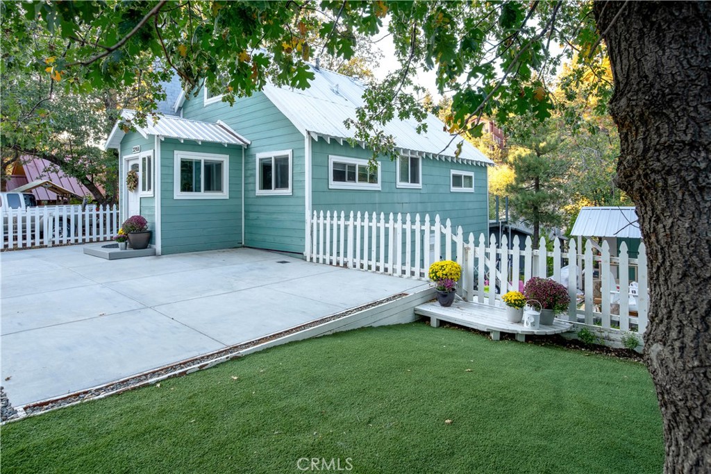 32958 Squirrel Lane Running Springs, CA 92382 - Photo 4 of 40 a front view of a house with sitting area and garden