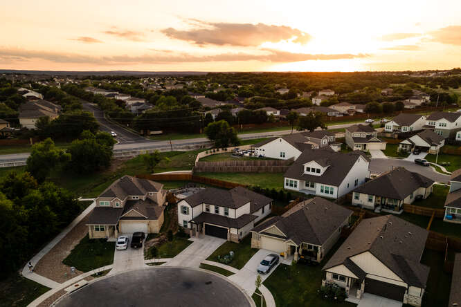 an aerial view of a houses with a city street