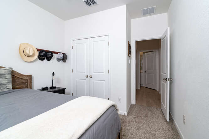 170 Corral Cove Kyle, TX 78640 - Photo 15 of 25 a bedroom with a bed and a chandelier