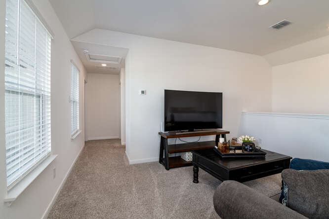 170 Corral Cove Kyle, TX 78640 - Photo 17 of 25 a living room with furniture and a flat screen tv