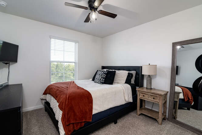 170 Corral Cove Kyle, TX 78640 - Photo 20 of 25 a bedroom with a bed and a flat tv screen on the dresser