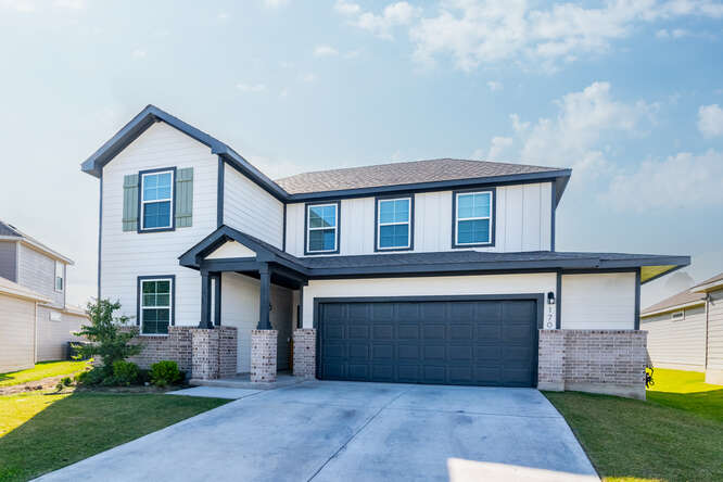170 Corral Cove Kyle, TX 78640 - Photo 22 of 25 a front view of a house with garden