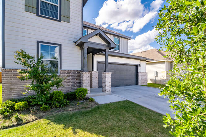 170 Corral Cove Kyle, TX 78640 - Photo 4 of 25 a front view of a house with garden