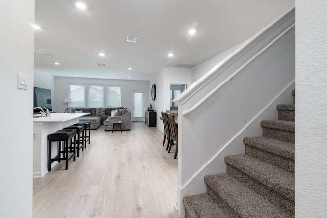 170 Corral Cove Kyle, TX 78640 - Photo 8 of 25 a living room with furniture and a dining table with wooden floor