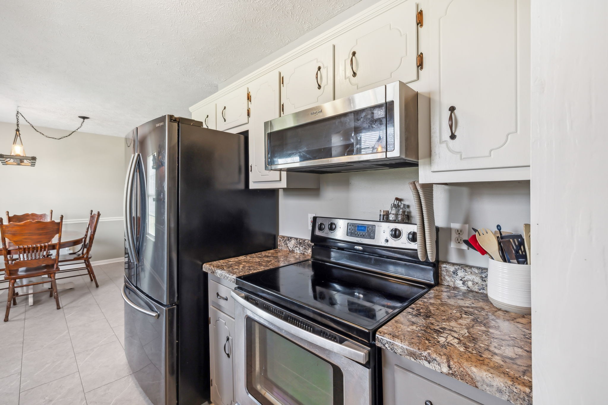 1055 Anderton Road Bell Buckle, TN 37020 - Photo 16 of 51 a kitchen with stainless steel appliances granite countertop a stove and a refrigerator