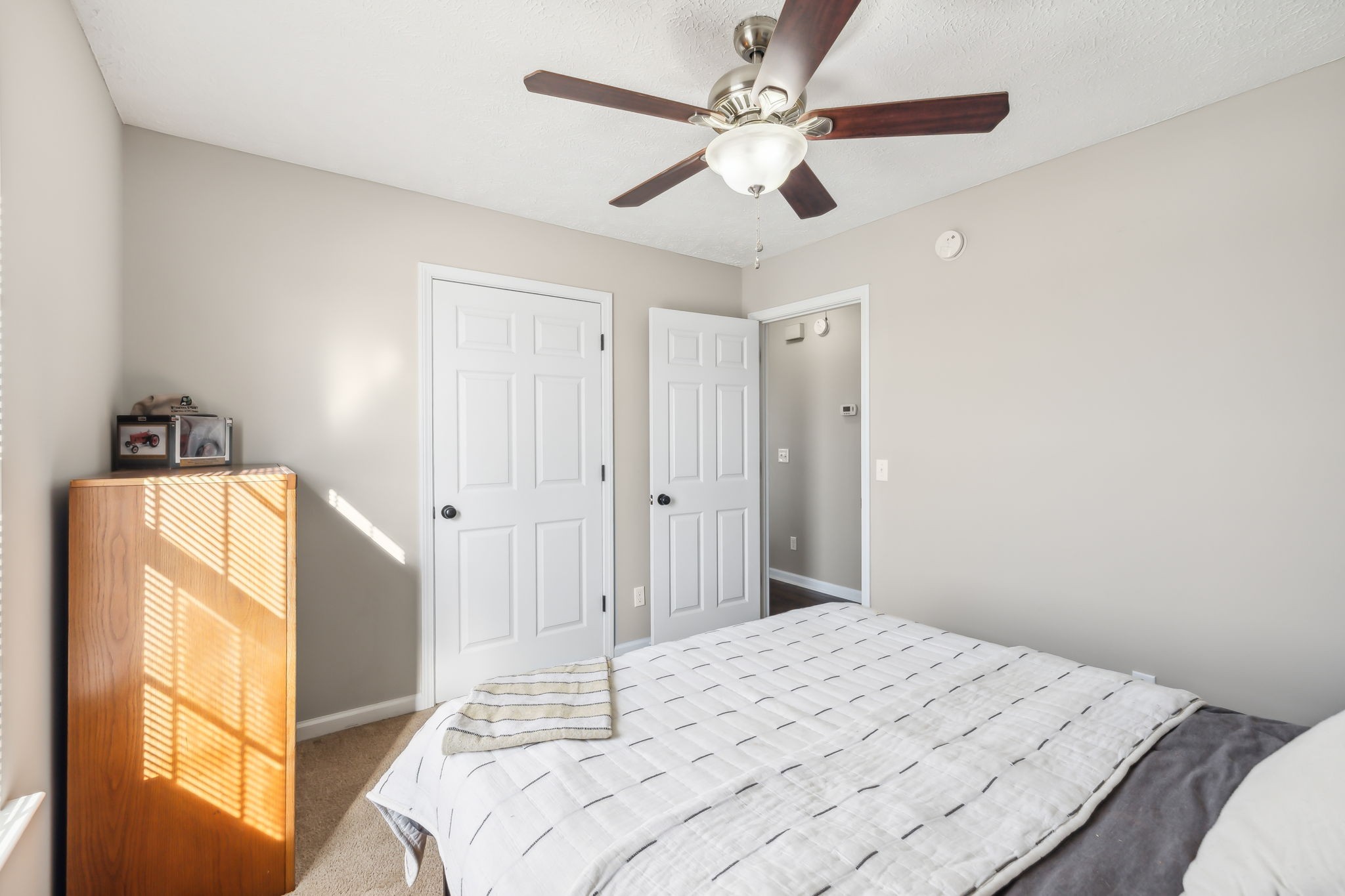 1055 Anderton Road Bell Buckle, TN 37020 - Photo 21 of 51 a bedroom with a bed and a chandelier