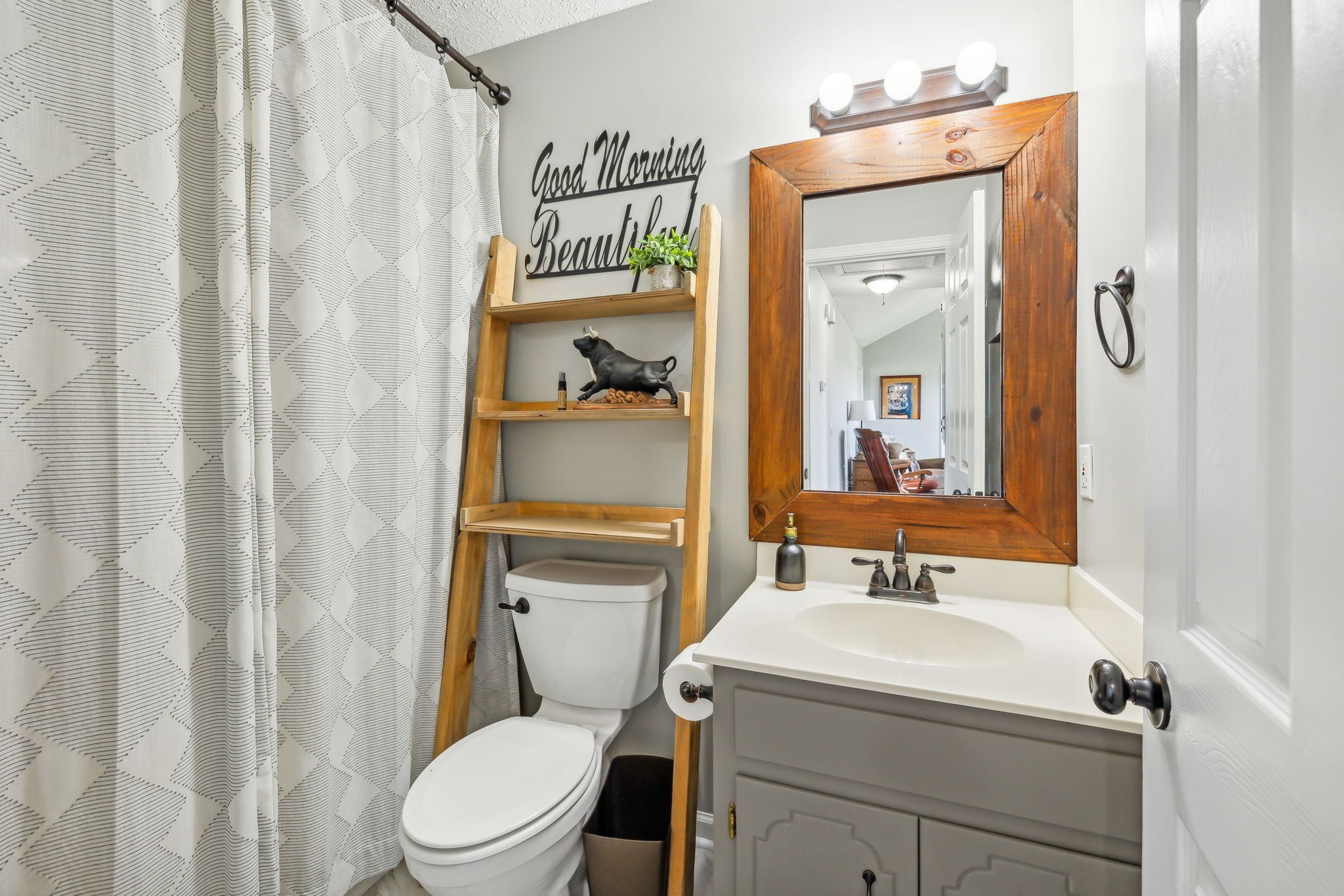 1055 Anderton Road Bell Buckle, TN 37020 - Photo 22 of 51 a bathroom with a sink a toilet and shower curtain