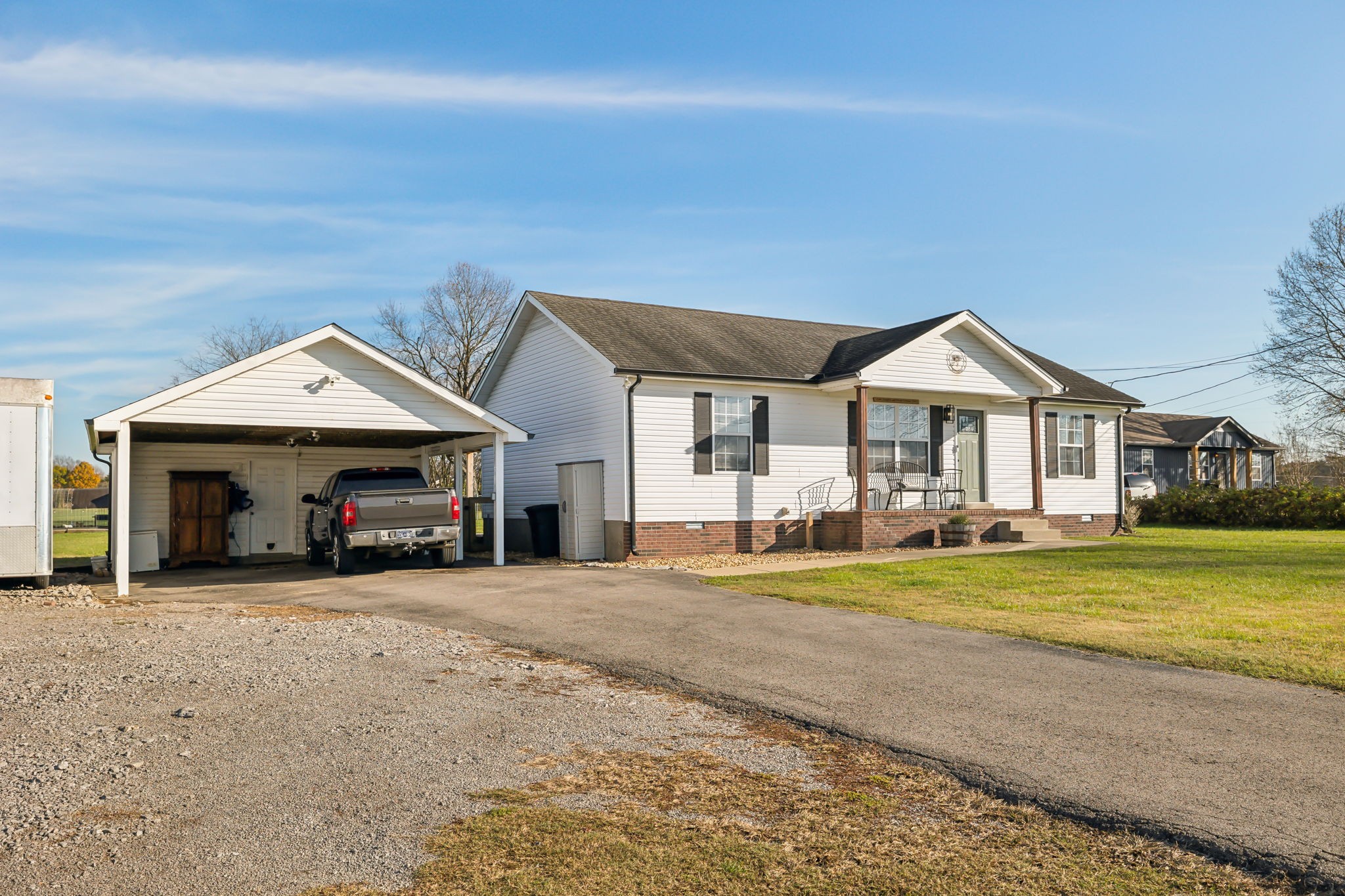 1055 Anderton Road Bell Buckle, TN 37020 - Photo 4 of 51 a view of a house next to a yard with big trees and plants