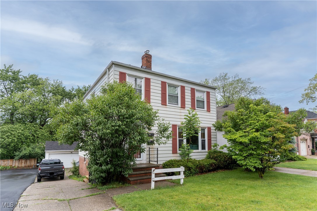 14220 Triskett Road Cleveland, OH 44111 - Photo 1 of 32 Colonial house featuring a chimney and a front lawn