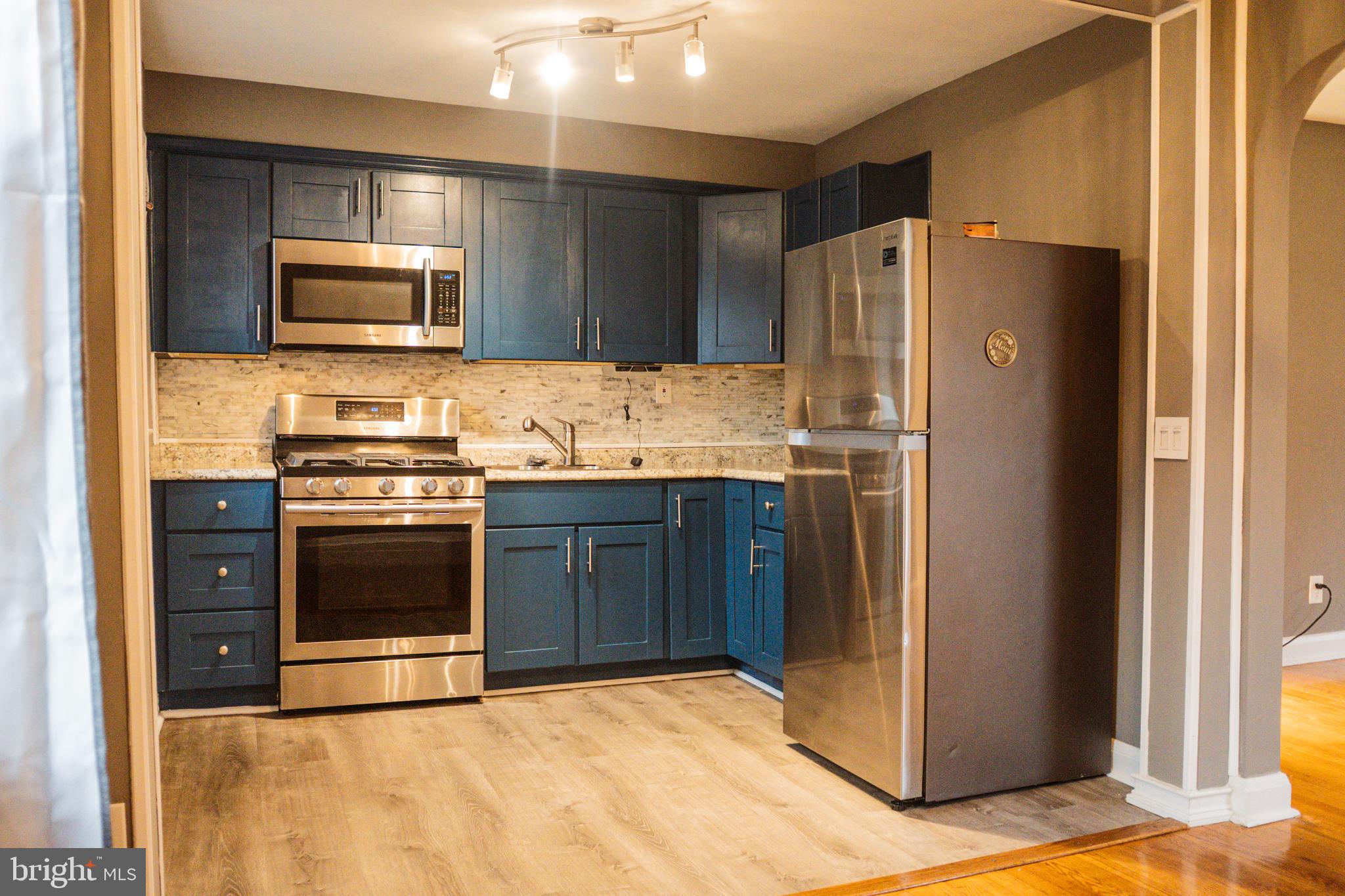 3402 Mayfair Road Baltimore, MD 21207 - Photo 12 of 48 a kitchen with stainless steel appliances granite countertop a refrigerator stove and sink