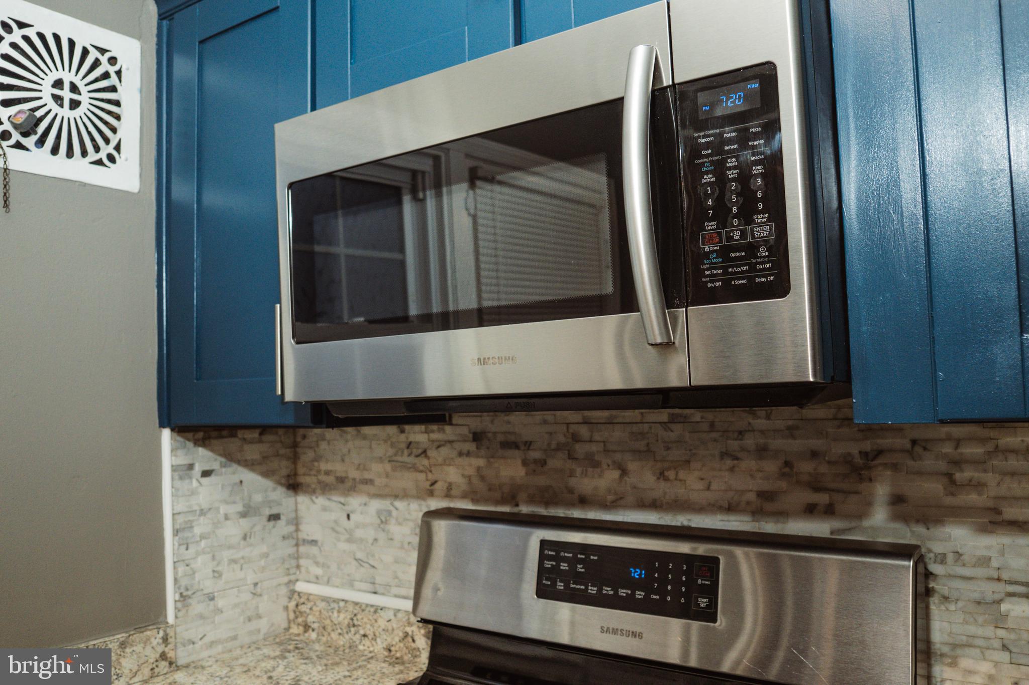 3402 Mayfair Road Baltimore, MD 21207 - Photo 16 of 48 a close view of a microwave and stove in a kitchen