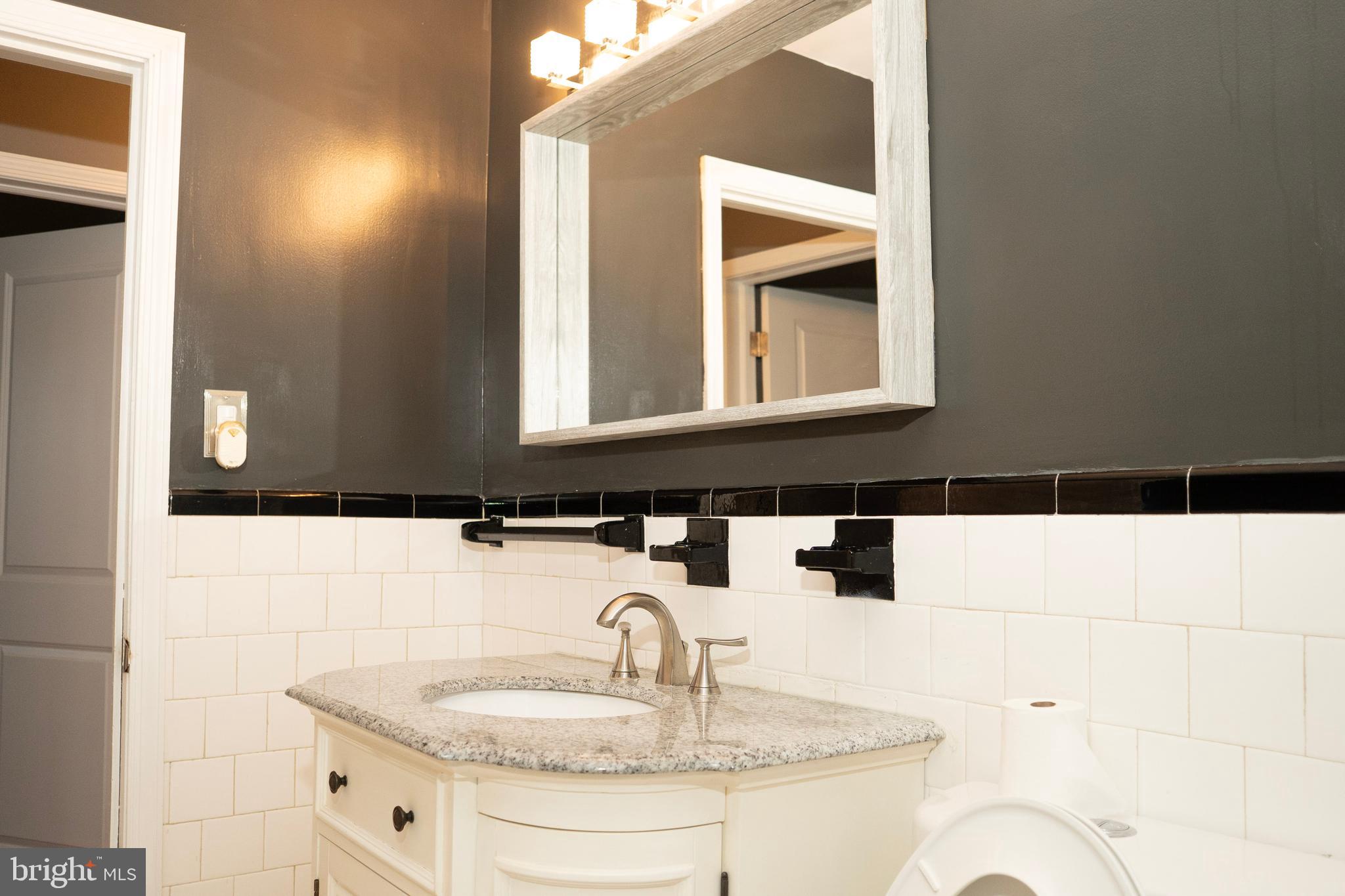 3402 Mayfair Road Baltimore, MD 21207 - Photo 19 of 48 a bathroom with a sink and a mirror