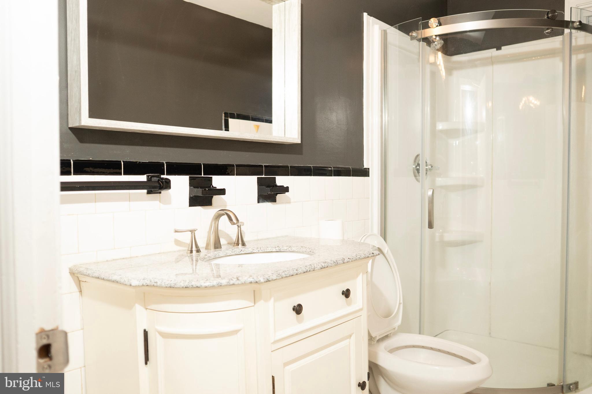3402 Mayfair Road Baltimore, MD 21207 - Photo 20 of 48 a bathroom with a granite countertop sink toilet and shower