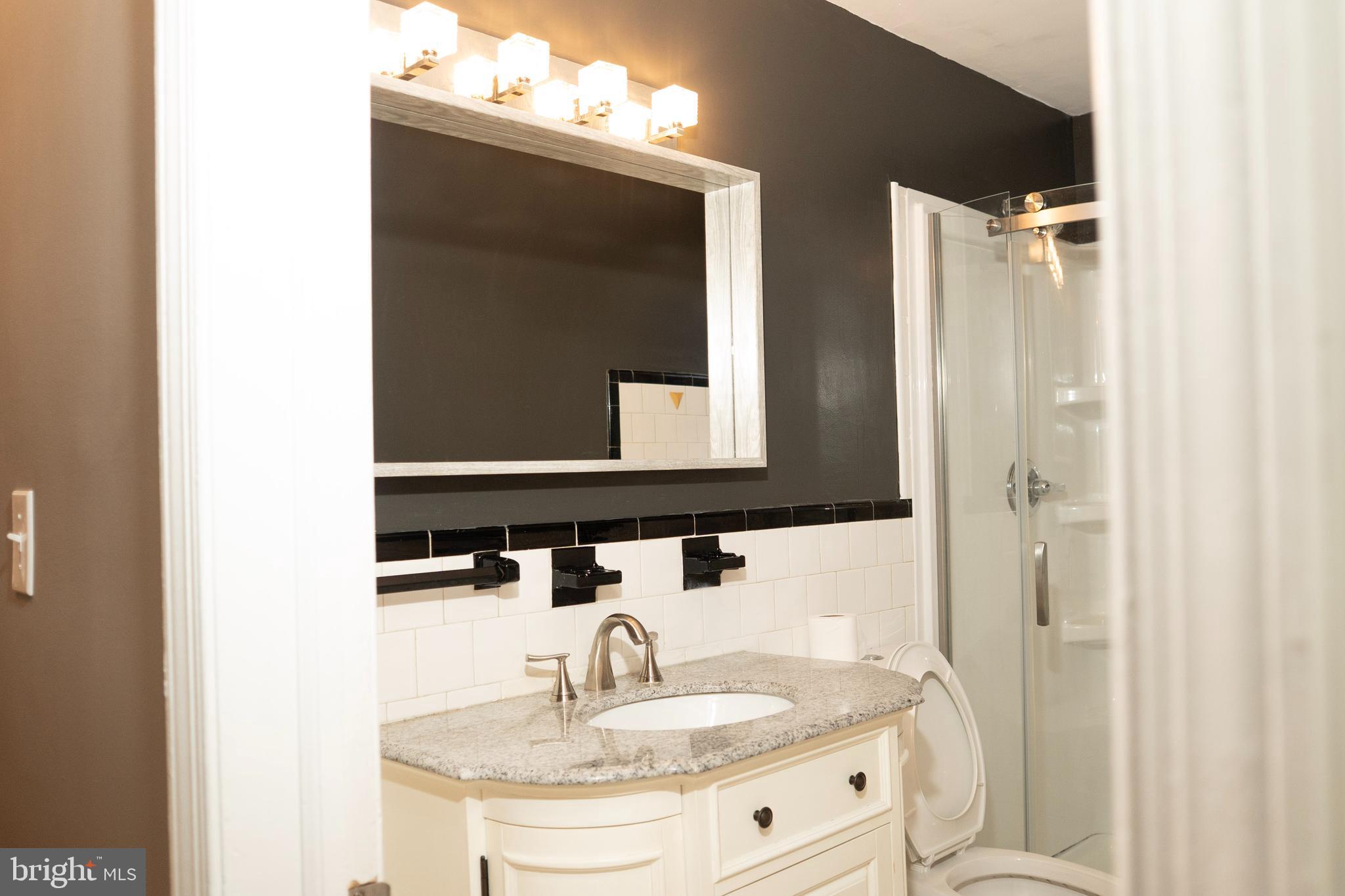 3402 Mayfair Road Baltimore, MD 21207 - Photo 21 of 48 a bathroom with a sink and a mirror