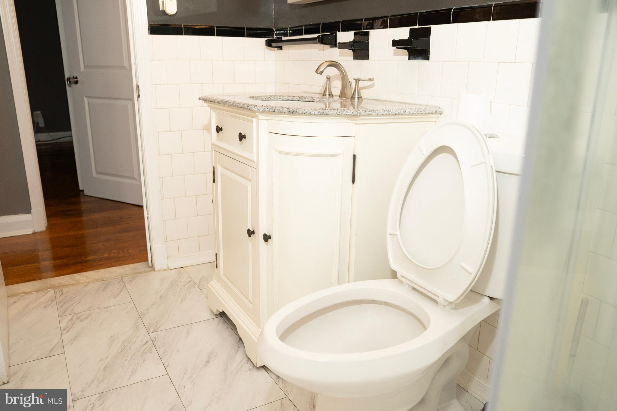 3402 Mayfair Road Baltimore, MD 21207 - Photo 23 of 48 a bathroom with a sink and a mirror