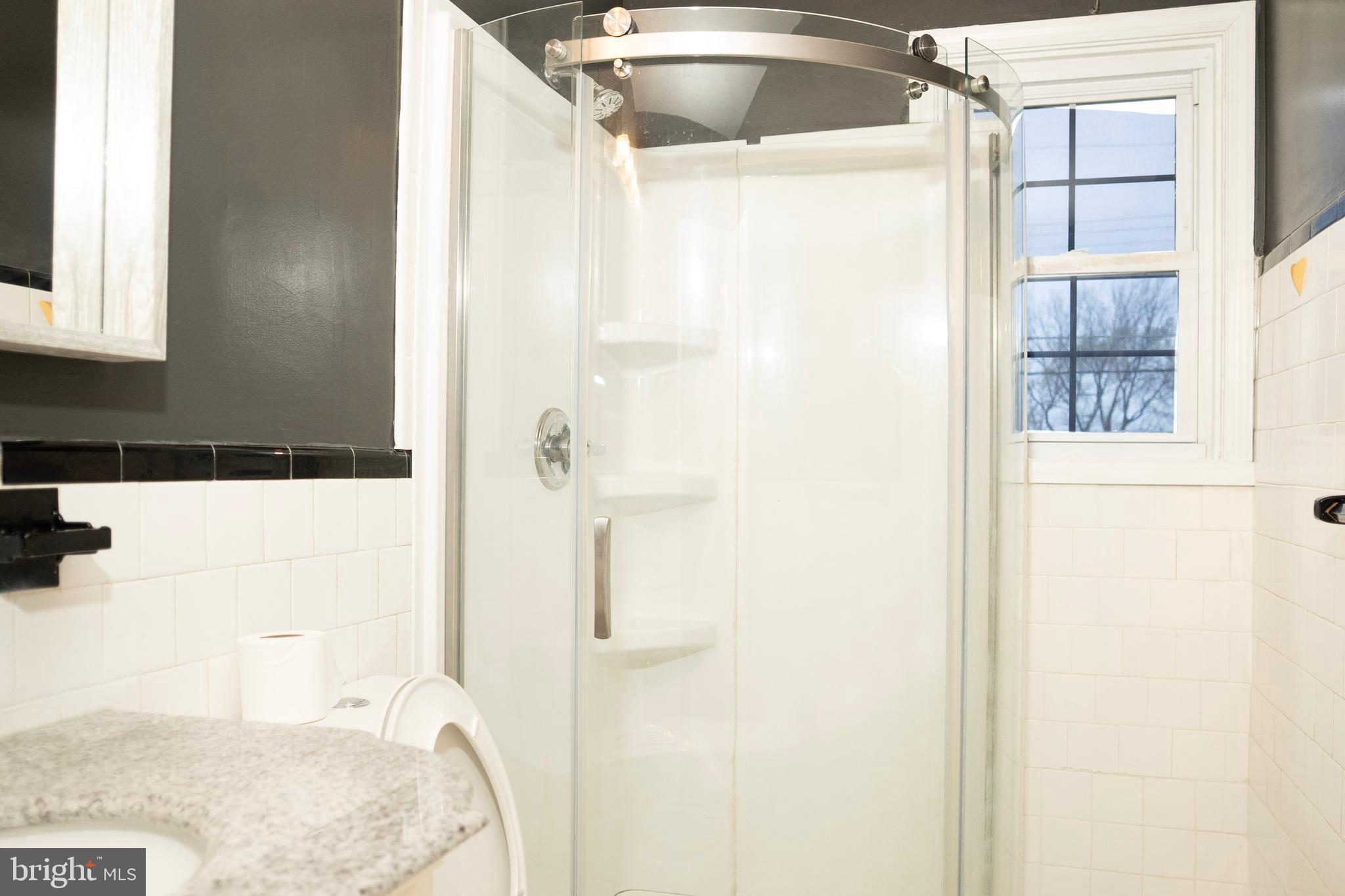 3402 Mayfair Road Baltimore, MD 21207 - Photo 24 of 48 a bathroom with a bathtub and shower