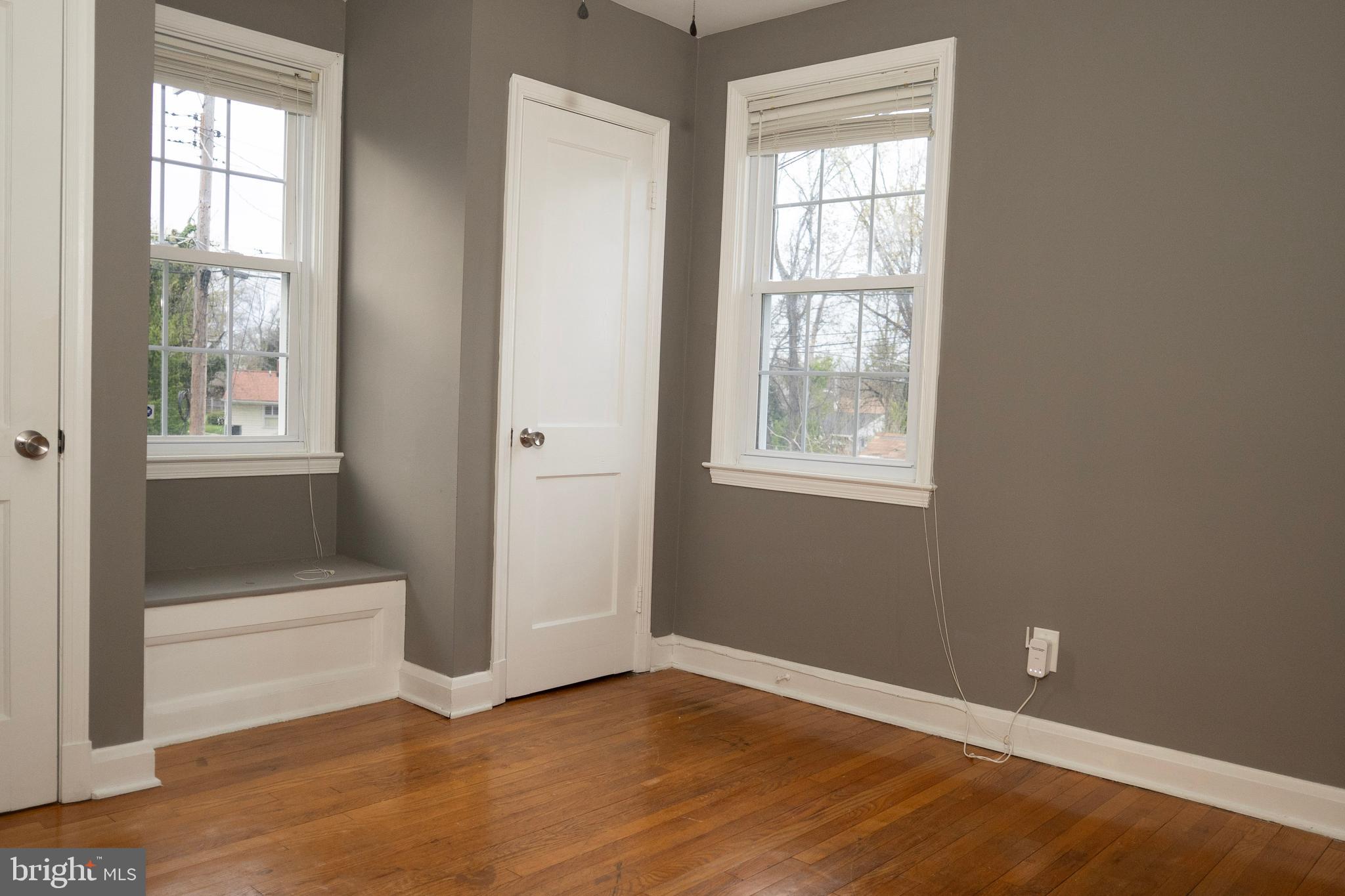 3402 Mayfair Road Baltimore, MD 21207 - Photo 28 of 48 a view of an empty room with wooden floor and a window