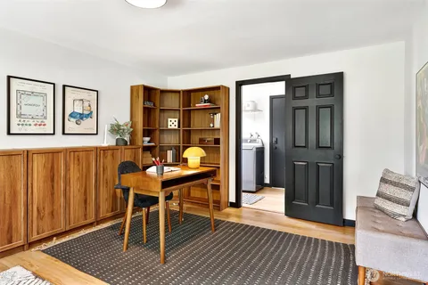 a workspace with wooden floor and furniture