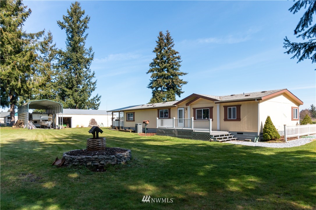 5004 186th Lane Southwest Rochester, WA 98579 - Photo 1 of 27 a front view of house with yard and green space