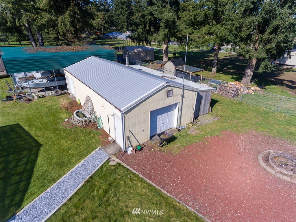 5004 186th Lane Southwest Rochester, WA 98579 - Photo 2 of 27 a backyard of a house with table and chairs