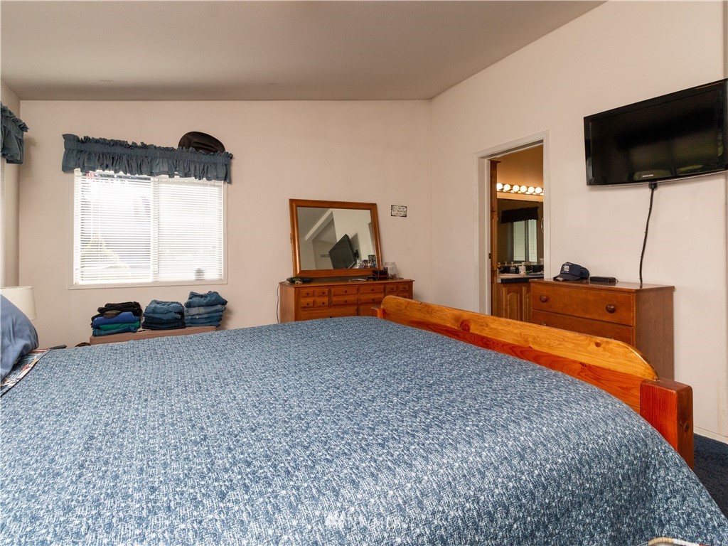 5004 186th Lane Southwest Rochester, WA 98579 - Photo 15 of 27 a bedroom with bed and flat screen tv