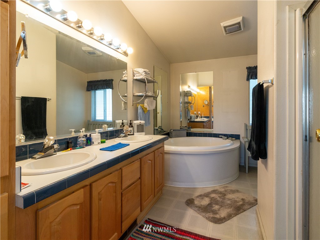 5004 186th Lane Southwest Rochester, WA 98579 - Photo 16 of 27 a bathroom with a sink a toilet and a mirror