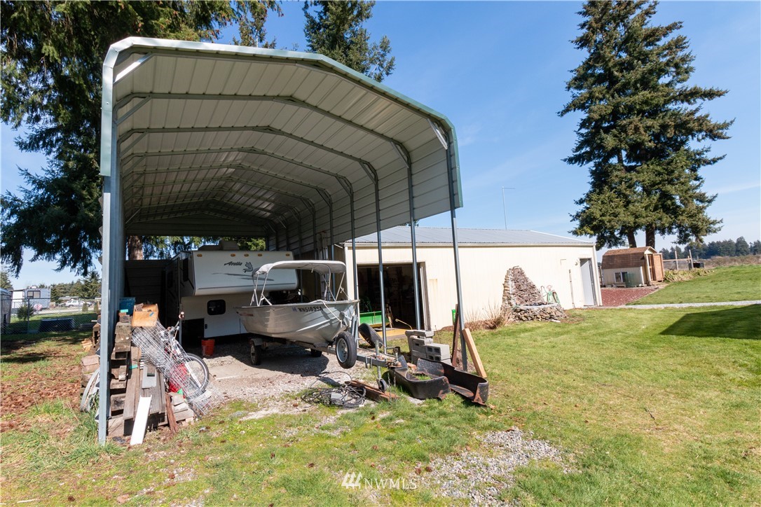5004 186th Lane Southwest Rochester, WA 98579 - Photo 18 of 27 a view of a chairs and fire pit in the yard