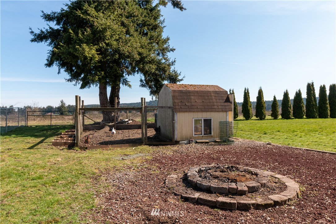 5004 186th Lane Southwest Rochester, WA 98579 - Photo 19 of 27 a view of a house with backyard