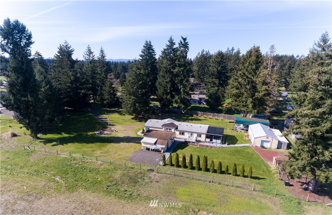 5004 186th Lane Southwest Rochester, WA 98579 - Photo 27 of 27 a backyard of a house with yard swimming pool and outdoor seating