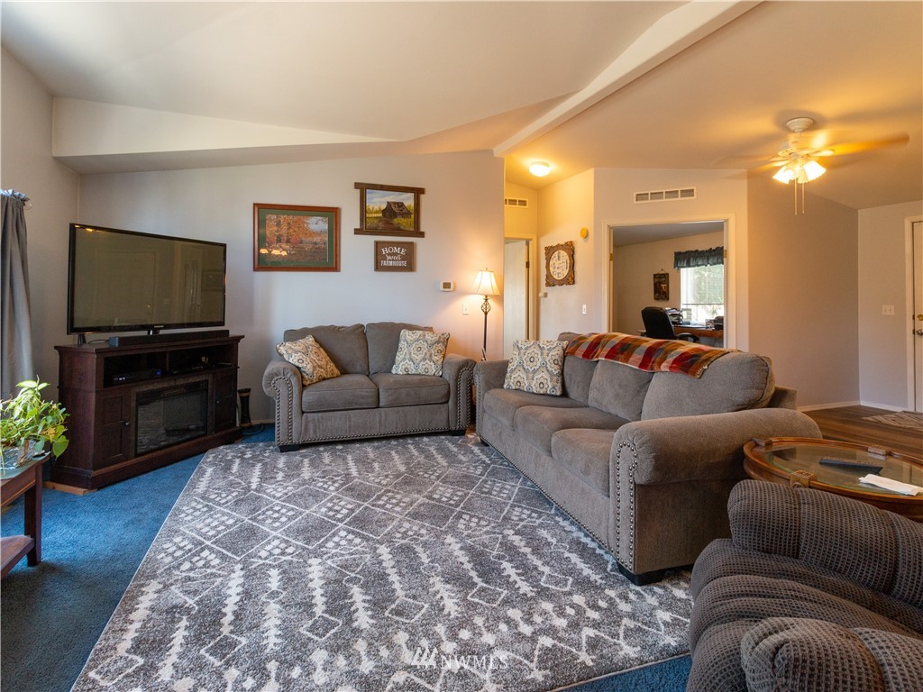 5004 186th Lane Southwest Rochester, WA 98579 - Photo 5 of 27 a living room with furniture and a flat screen tv
